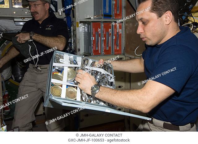 Russian cosmonaut Anton Shkaplerov, Expedition 30 flight engineer, makes a selection from a food storage container in the Zvezda Service Module of the...