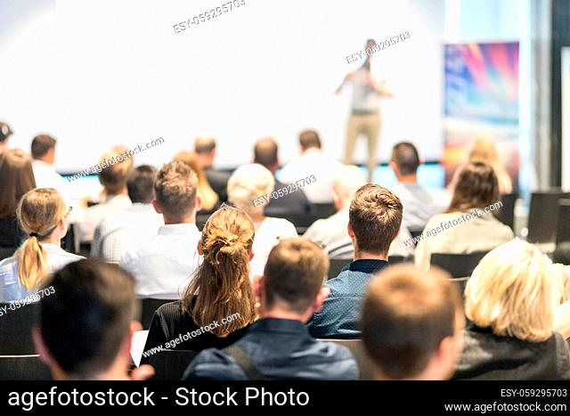 Speaker giving a talk in conference hall at business event. Audience at the conference hall. Business and Entrepreneurship concept