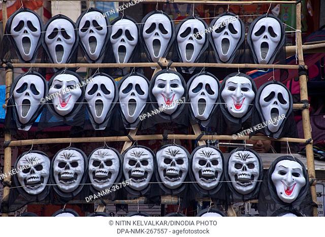 Plastic masks of Ghost and Skull kept for sell, Pune Maharashtra India Asia