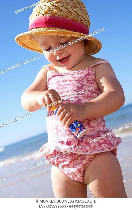 Young Girl Playing With Bubbles On Sunny Beach