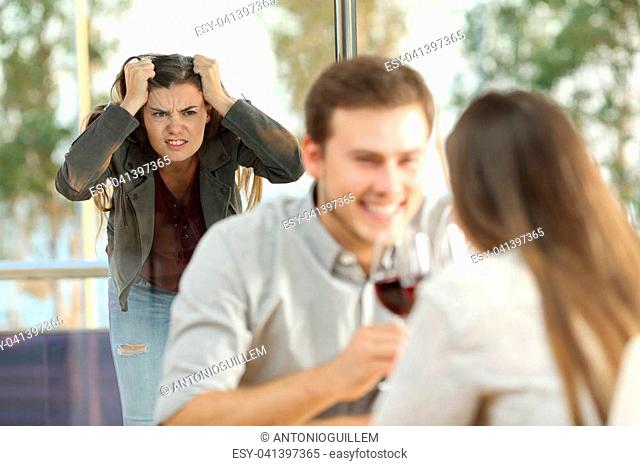 Disloyal boyfriend caught by his angry girlfriend dating with another girl in a restaurant