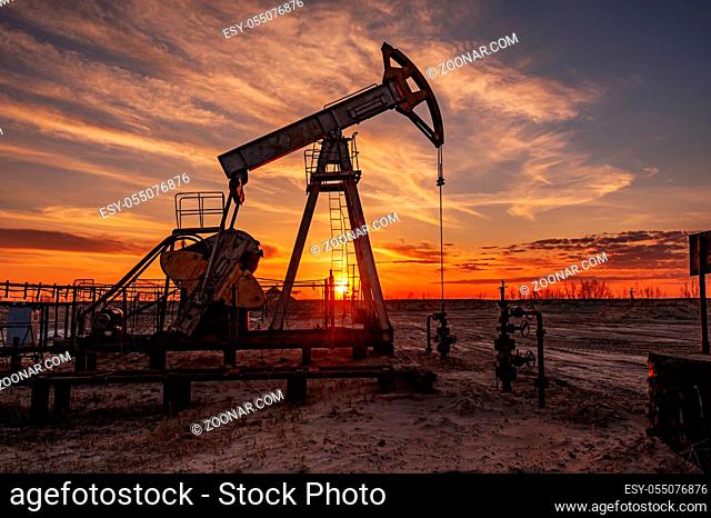 Oil pump rig. Oil and gas production. Oilfield site. Pump Jack are running. Drilling derricks for fossil fuels output and crude oil production