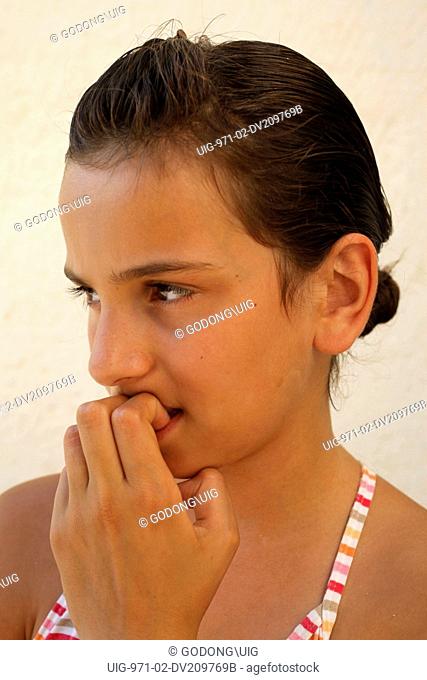 Girl biting nails, Italy