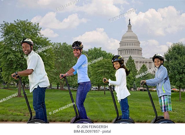 African American family sightseeing segways on vacation