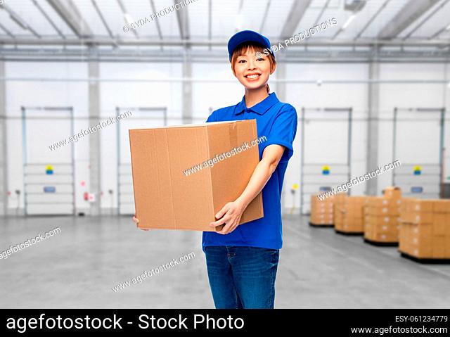 delivery woman with parcel box at warehouse