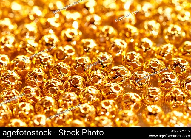 Beautiful golden metal beads - closeup photo