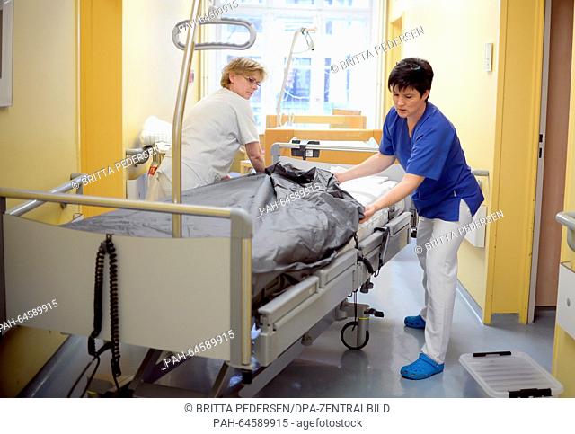 Hospital aides Andrea Dede (L) and Claudia Schreiner prepare a bed in the palliative care ward at Charite hospital in Berlin, Germany, 07 December 2015