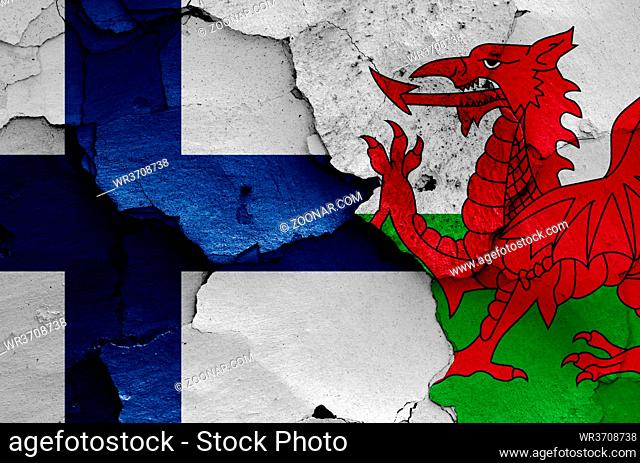 flags of Finland and Wales painted on cracked wall