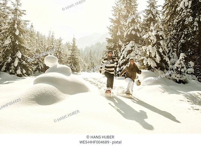 Austria, Salzburg State, Altenmarkt-Zauchensee, Couple snowshoeing in winter landscape