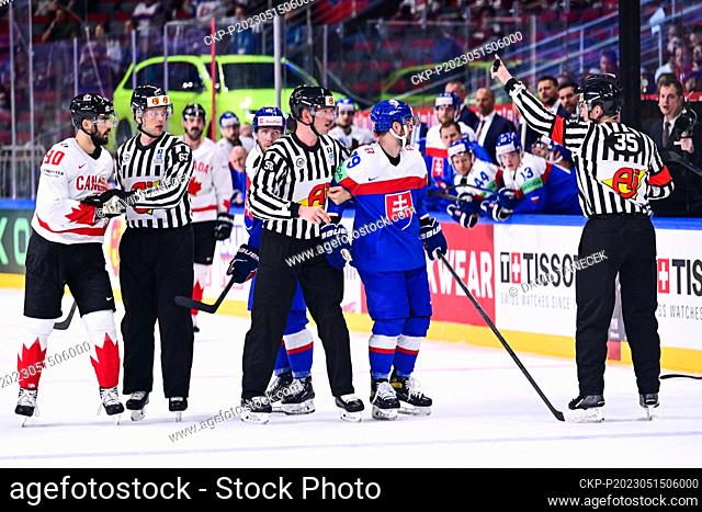 L-R Joe Veleno (CAN), referees and Libor Hudacek (SVK) who receives a penalty of 5 minutes plus until the end of the match during the IIHF Ice Hockey World...