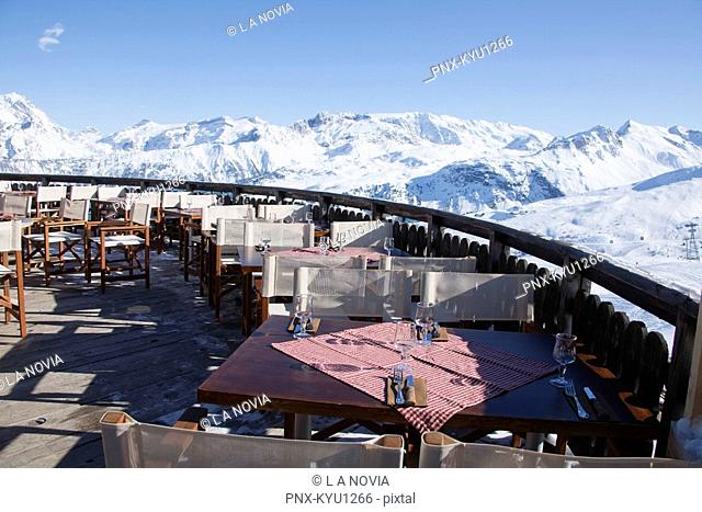 Restaurant terrace surrounded by snow covered mountains