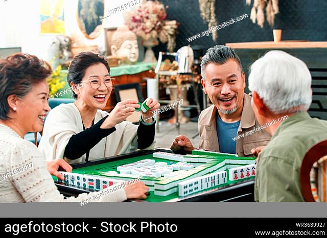 Happy old friends playing mahjong