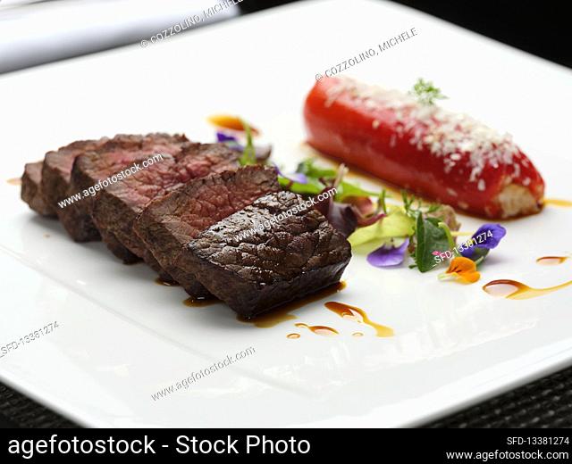 Roasted Beef steak with stuffed pepper, herbs and flowers