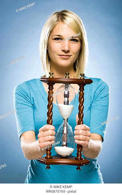 woman holding an hourglass