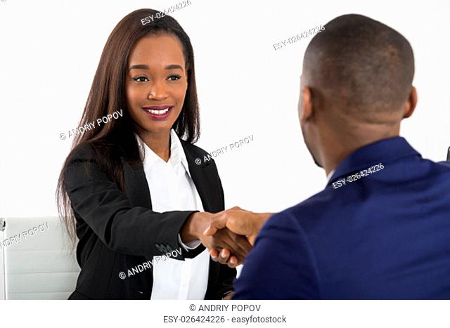 Two Successful African American Businesspeople Shaking Hands At Office