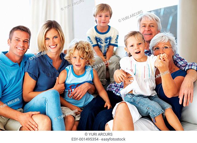 Portrait of happy three generation family spending time together at home