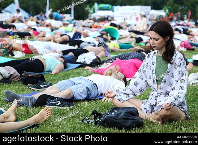 RUSSIA, MOSCOW - JULY 2, 2023: A woman meditates during Yoga Day Russia 2023, a yoga festival marking the International Day of Yoga, in Tsaritsyno Park