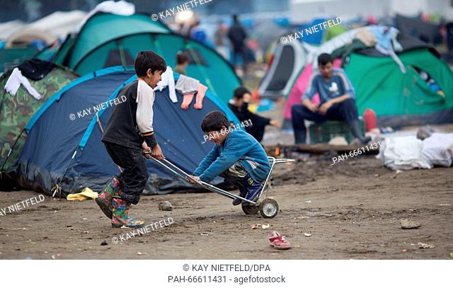 A refugee child playing in the dirt in the refugee camp at the border between Greece and Macedonia, Idomeni, Greece, 11 March 2016