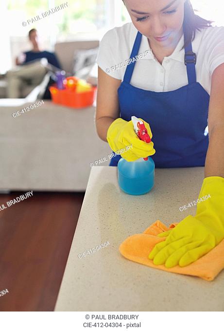 Maid cleaning kitchen counter