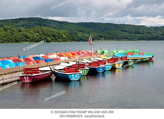 Colorful rowboats and pedalos for rental in a German lake
