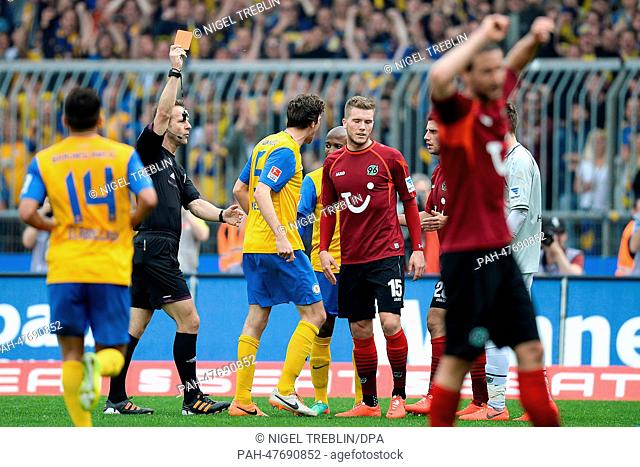 Hanover's Andre Hoffmann (5TH-L) receives a red card of referee Peter Gagelmann (2ND-L) during the Bundesliga soccer match between Eintracht Braunschweig at the...