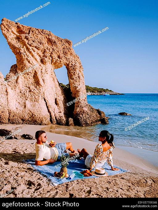 Tropical beach of Voulisma beach, Istron, Crete, Greece , Most beautiful beaches of Crete island -Istron bay near Agios Nikolaos young couple mid age on...