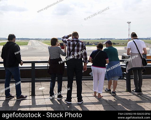 02 September 2023, Brandenburg, Schönefeld: Visitors of the farewell party of the airport community Schönefeld of Terminal 5 stand on the former visitor terrace