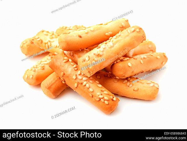 Pile of breadsticks with sesame isolated on white