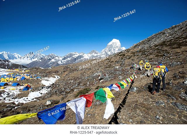 A team of four climbers return to base camp after climbing Ama Dablam in the Nepal Himalayas, Khumbu Region, Nepal, Asia
