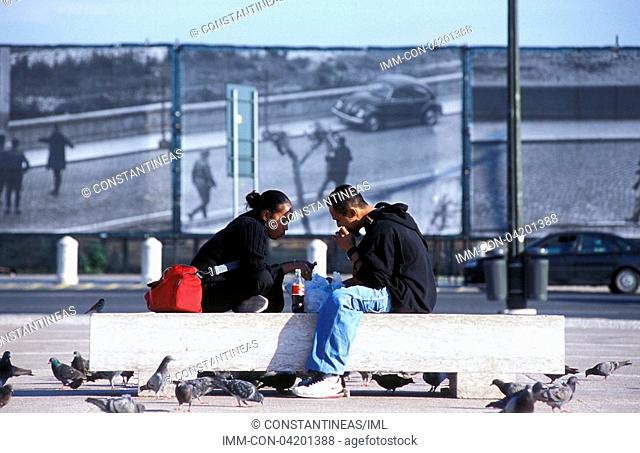 Baixa, Pracio do Comercio, couple eating on a bench , Lisbon, Portugal, Europe