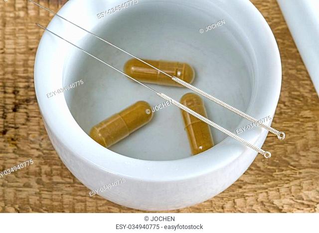 acupuncture needles with mortar and chinese herbal pills