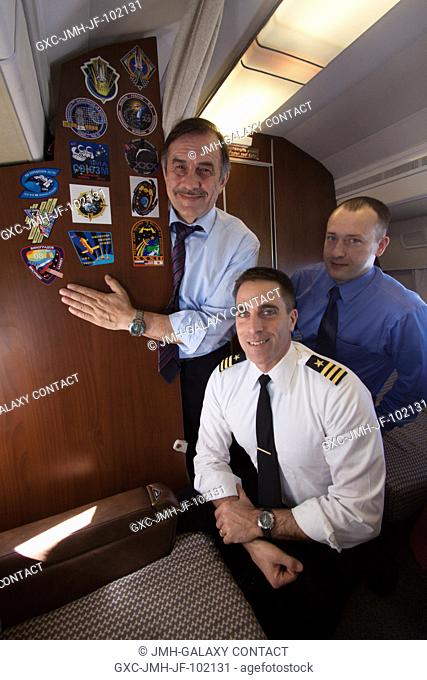 Aboard a Russian Federal Space Agency aircraft headed for their launch site, Expedition 3536 Soyuz Commander Pavel Vinogradov (left)