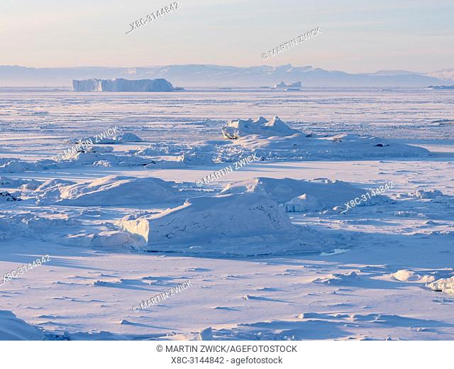 The frozen Disko Bay with icebergs at the Ilulissat Icefjord . The icefjord is listed as UNESCO world heritage. America, North America, Greenland, Denmark