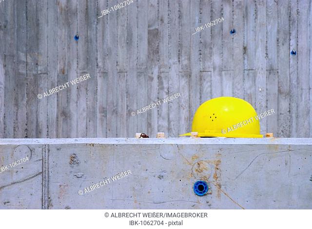 Yellow hardhat on a concrete wall, Germany, Europe