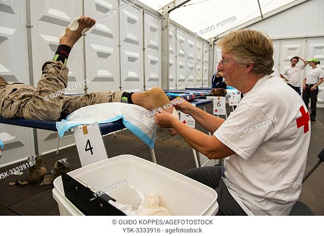 Nijmegen, Breukelen, Netherlands. Red Cross medical staff taking care of blisters and injuries at the first aid post during the Nijmegen Four Day March 2017