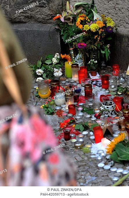 Flowers, candles and cards sit on the ground in front of the Rheingau school in Berlin, Germany, 27 August 2013. According to the Foreign Office