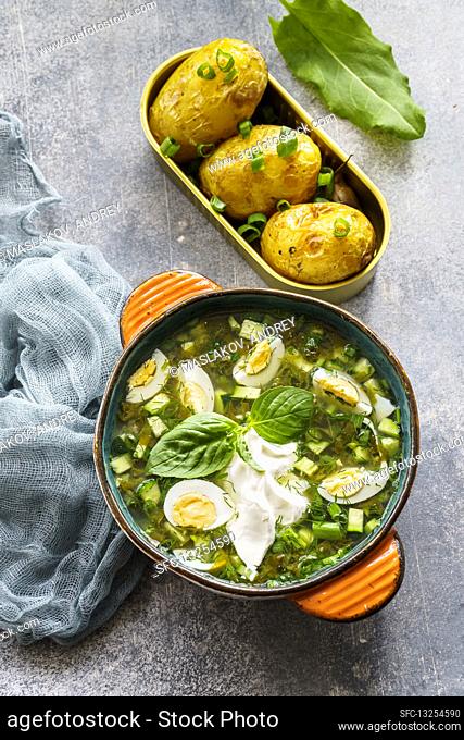 Cold sorrel soup with cucumbers, herbs and quail eggs (Russian soup)