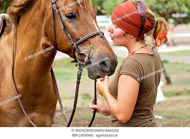 A woman calming her horse