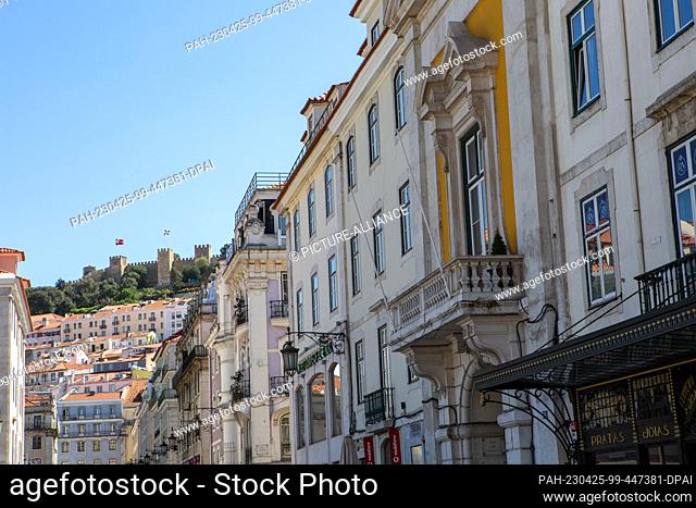 PRODUCTION - 05 April 2023, Portugal, Lissabon: On top of the mountain is the fortress ""Castelo de Sao Jorge"", seen from downtown Lisbon near Rossio
