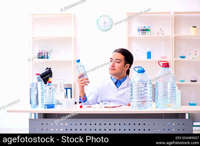 The young male chemist experimenting in lab