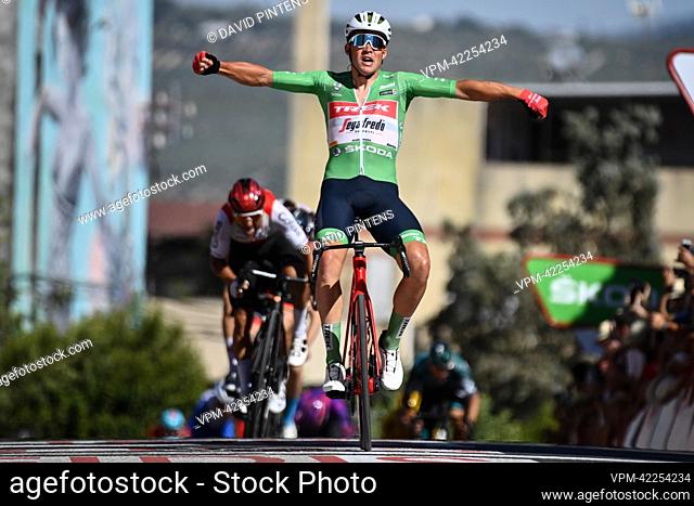 Danish Mads Pedersen of Trek-Segafredo wearing the green points jersey celebrates as he crosses the finish line to win stage 13 of the 2022 edition of the...