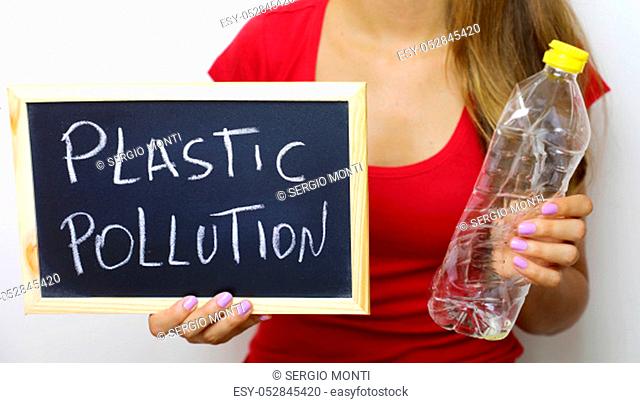 Woman holding plastic bottle cooking oil and blackboard with the written Plastic pollution