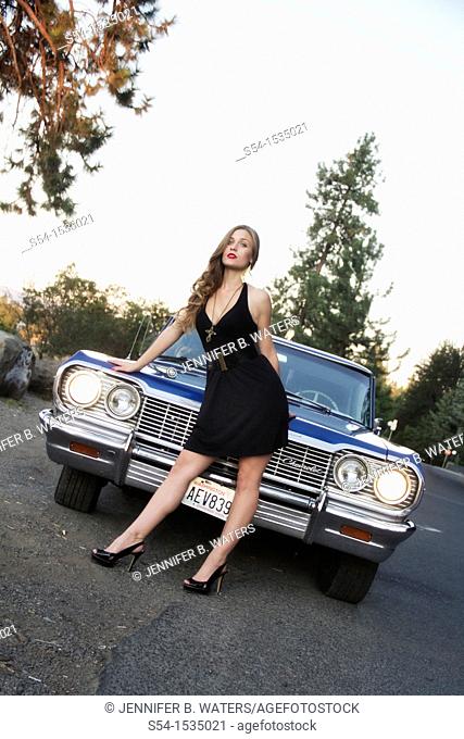 A young woman with a 1964 Chevrolet Impala in Spokane, Washington, USA