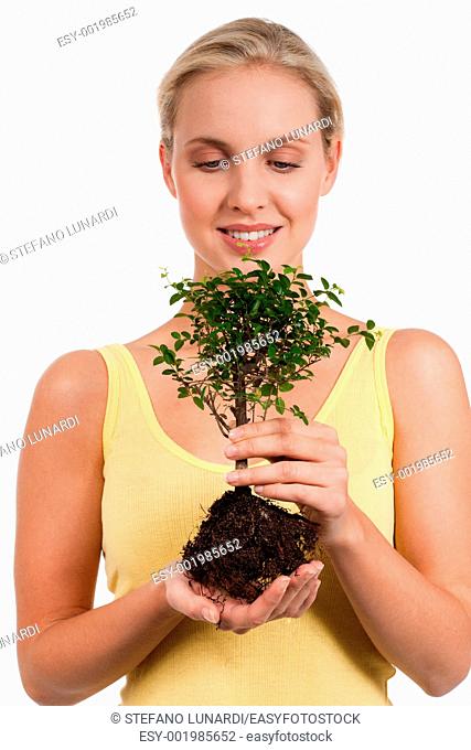 Young woman holding a bonsai tree, isolated on white  Concept: new life