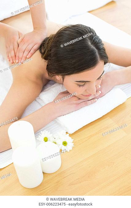 Beautiful woman enjoying back massage at beauty spa
