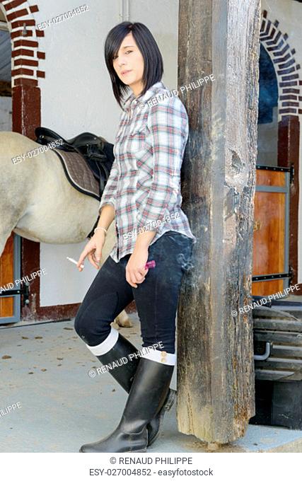 beautiful brunette girl dressed in horse riding clothes