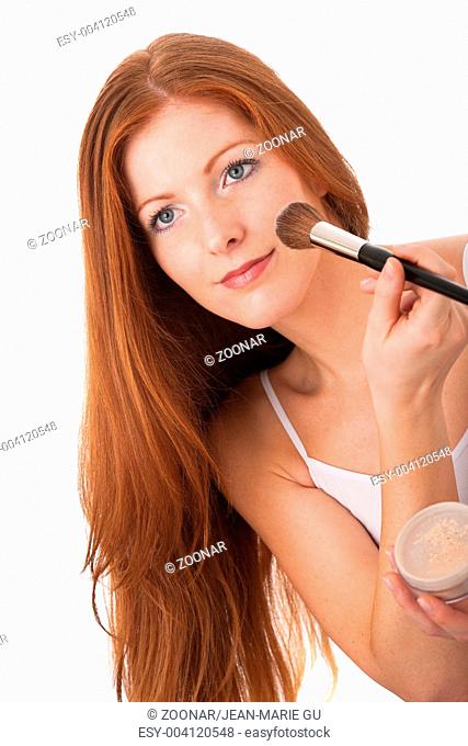 Body care series - Beautiful red hair woman applying powder