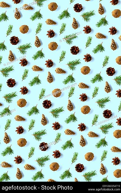 Creative Pine cone Christmas background on blue. Pine branches and cones. minimal creative cone arrangement pattern. flat lay, top view