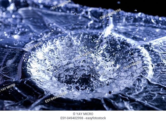 Water drops splashing on acoustic membrane. A lot of drops in air. High frequency of sound waves. Water cloud small drops. Frozen time shot
