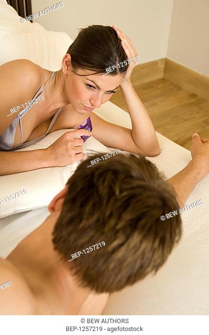 Man and woman holding condom